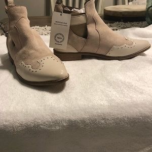 Soft pink leather ankle boots .